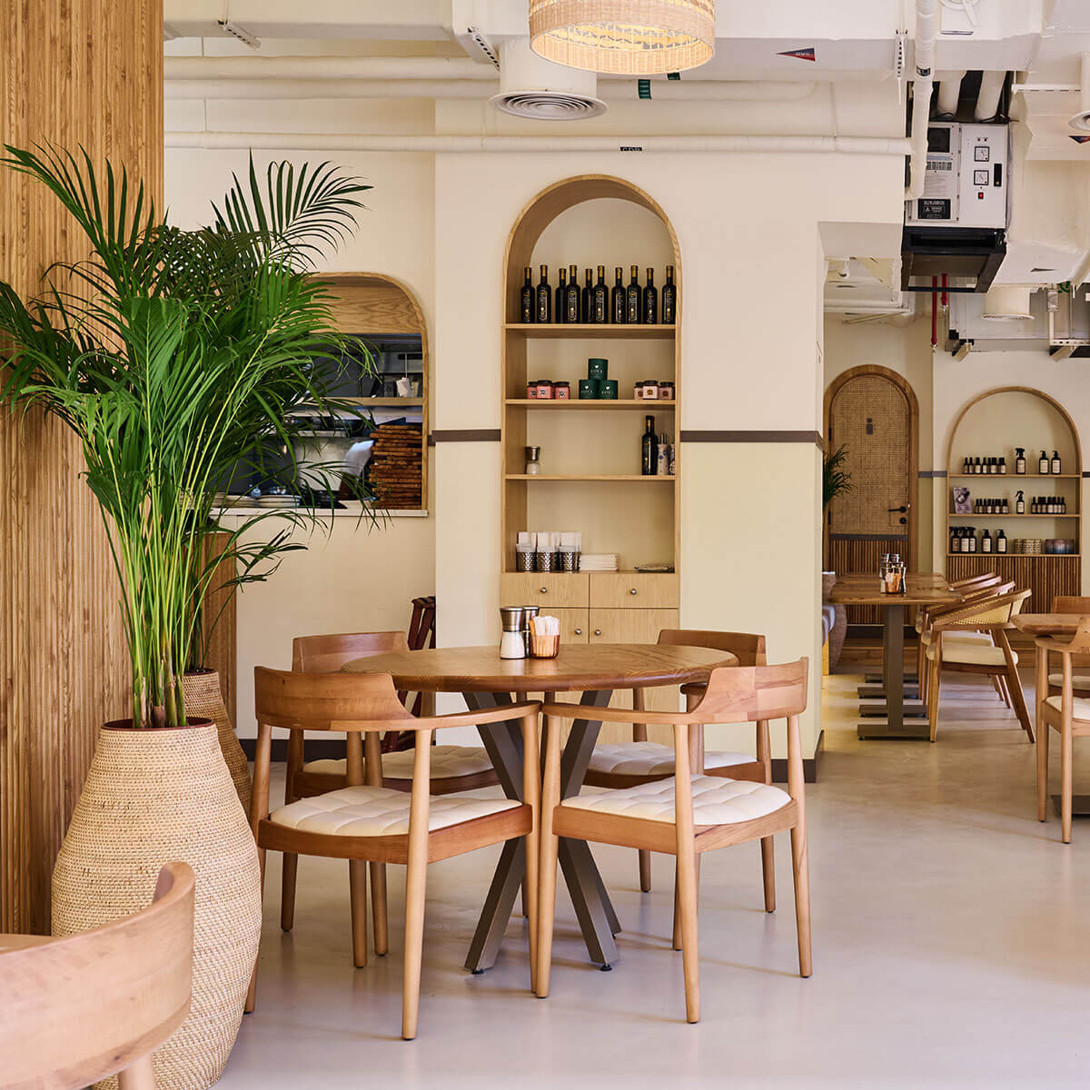 Apricot Deli indoor seating with tables and chairs with live plants